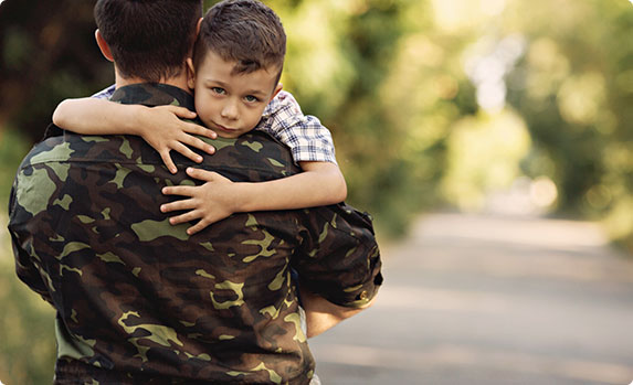 A soldier and a young boy sharing a heartwarming bond - The Family Law Firm Of Tampa Bay.